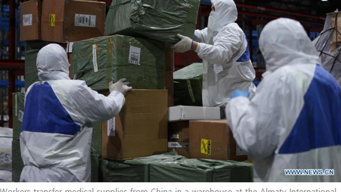 Workers transfer medical supplies from China in a warehouse at the Almaty International Airport in Almaty, Kazakhstan